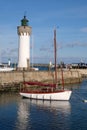 Breton port on the Atlantic coast with boats and a lighthouse