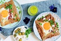 Breton traditional pancake made from buckwheat flour with ham, cheese, egg, feta, green peas and green butter.