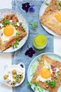 Breton traditional pancake made from buckwheat flour with ham, cheese, egg, feta, green peas and green butter.