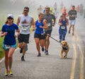 BREVARD, NC-MAY 28, 2016 -Happy woman and her dog run in the White Squirrel Race in Brevard, NC 2016. Race is sponsored by Rotary