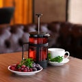 Brewed tea made from frozen berries, blackberries, raspberries and cherries with mint. Glass French press with hot tea Royalty Free Stock Photo