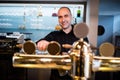 Brewer filling beer in beer glass from beer pump Royalty Free Stock Photo