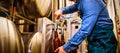 Brewer filling beer in bottle