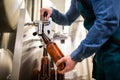 Brewer filling beer in bottle Royalty Free Stock Photo