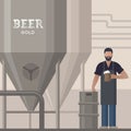 Brewer in own brewery with a beer in the hand demonstrating beer production. Royalty Free Stock Photo