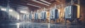 Brewery or alcohol production factory. Large steel fermentation tanks in spacious hall