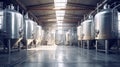 Brewery or alcohol production factory. Large steel fermentation tanks in spacious hall