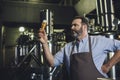 Brewery worker with glass of beer Royalty Free Stock Photo