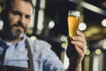 Brewery worker with glass of beer Royalty Free Stock Photo