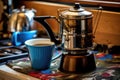 brewing coffee in a vintage enamel pot on a camp stove