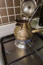 Brewing fresh coffee in bronze turkish cezva