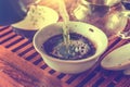 Brewing tea with boiling water in ceramic gaiwan