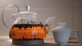 Brewing tea in glass teapot. Concept. Beautiful tea brewing in transparent teapot with white cups. Art of brewing Royalty Free Stock Photo