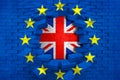 Brexit blue european union EU flag on broken brick wall with hole and great britain flag inside Royalty Free Stock Photo