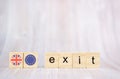 Brexit concept .Exit word written on wood blocks with British and EU flags. Exit text on wooden table for your desing Royalty Free Stock Photo