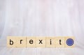 Brexit concept. Brexit word written on wood blocks with EU flag. Brexit text on wooden table for your desing Royalty Free Stock Photo