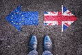 Brexit, flags of the United Kingdom and the European Union on asphalt road