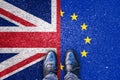 Brexit, flags of the United Kingdom and the European Union on asphalt road