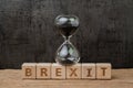 Brexit, time countdown for the UK to deal and withdraw from Euro zone concept, sandglass or hourglass on wooden cube block with