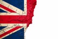 Brexit United Kingdom UK flag painted on cracked split peeling paint brick wall cement facade on white. Brexit concept image. Royalty Free Stock Photo