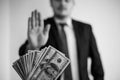 Bribe and corruption,offered cash to a businessman in a suit, does not want to take them, hold upright hands Royalty Free Stock Photo