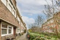 a brick alleyway between two houses with a bench