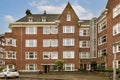 a brick apartment building with a car parked in front Royalty Free Stock Photo