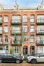 a brick apartment building with cars parked outside of it