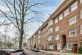 a brick apartment building with cars parked on the street