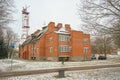 Brick apartment building and communication tower in Narva