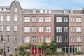 a brick apartment building with red doors and windows Royalty Free Stock Photo