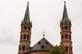 Brick Bell towers of WÃÂ¼rzburger Cathedral on cloudy sky Royalty Free Stock Photo