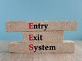 Brick blocks with the acronym EES- Entry Exit System. Beautiful blue background,wooden table. Business concept Royalty Free Stock Photo