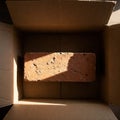 Brick in a box in sunlight. Royalty Free Stock Photo
