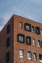 Brick brown modern building with black rectangular frame on windows Royalty Free Stock Photo