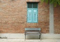 Brick building with blue wooden shuttered window