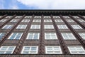 Brick building facade with endless rows of windows