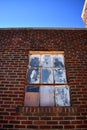 Old Painted Windows in a Brick Building Under Blue Sky