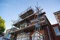 a brick building surrounded by scaffolding poles ready for construction work to take place Royalty Free Stock Photo