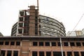 A brick building under construction with scaffolding along the walls. Royalty Free Stock Photo