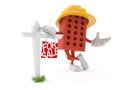 Brick character with real estate sign