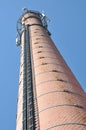 Brick chimney with cables antennas of telecommunication systems Royalty Free Stock Photo