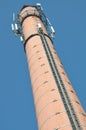 Brick chimney with cables antennas of telecommunication systems Royalty Free Stock Photo