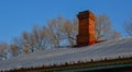 Brick chimney of old house with covered snow Royalty Free Stock Photo