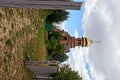 A brick church overgrown with greenery and a path in the grass near the fence Royalty Free Stock Photo