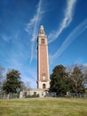 Brick clock tower with dramatic cloud patterns in sky Royalty Free Stock Photo
