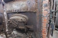 Brick coal burning boiler in machine room