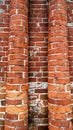 Brick columns of red brick, round in the city, abandoned building in the summer.