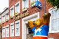 Brick facade of the Volksbank with logo ,lettering and Buddy Bear in the foreground ,Esens, Am Markt Royalty Free Stock Photo