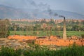 Brick factory with chimney and black smoke Royalty Free Stock Photo